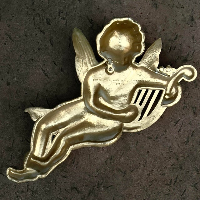 Vintage Syroco brand cast resin angel/ putti/ fairy / cupid wall hanging decoration. This winged creature is playing a...
