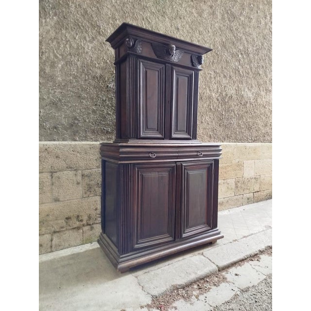A late 16th-century walnut sideboard, partially restored. Decorated with three hand-carved angel heads.