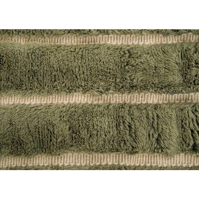 Luxurious Olive Green and Sage stripes highlight the plush texture of this artisan-crafted wool rug. Its subtle, modern...