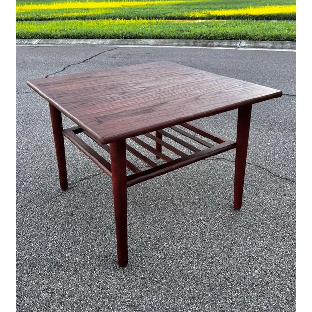 Mid-century Danish modern side table with slatted shelf. Sleek and minimal lines. Extra storage for magazines or books on...