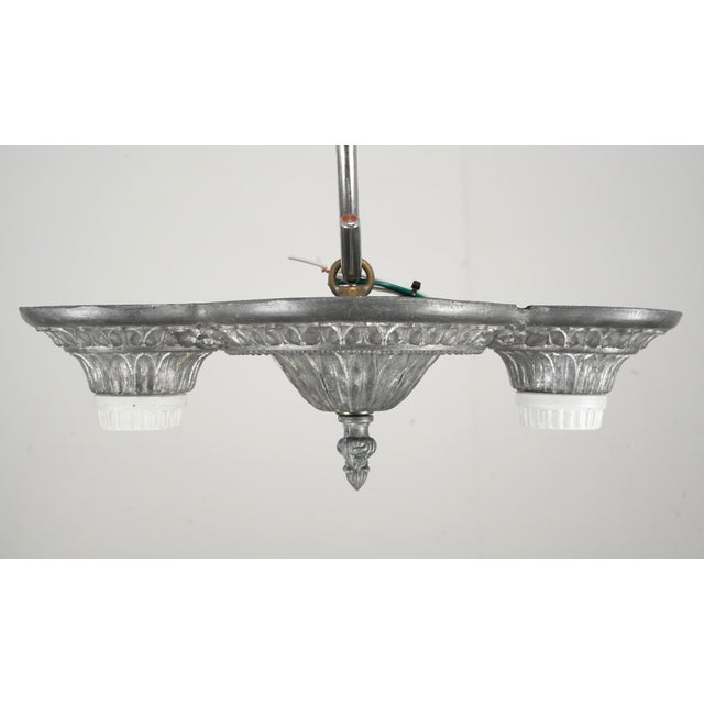 Early 20th century Art Deco style flush mount fixture with two exposed bulbs. It is made of brass with a pewter finish....