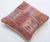 A one-of-a-kind handwoven Afghan wool kilim accent pillow featuring comb-and-triangle tribal motifs in purple and burnt...