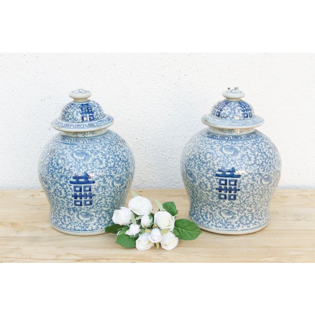 A pair like this earns its place as a room's focal point without trying hard. Each jar carries a dense, all-over floral...