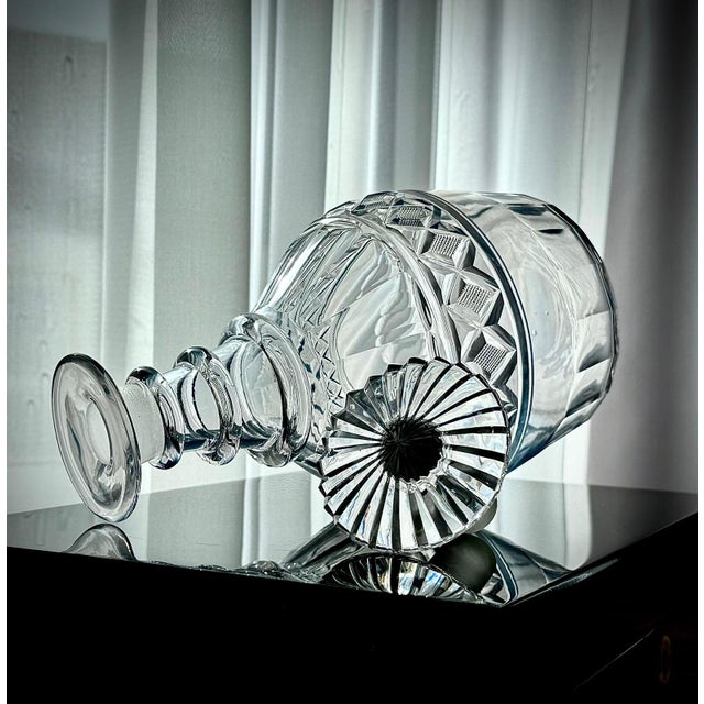 An authentic early 19th-century cut-glass decanter of late Georgian to Regency date. The decanter features a bulbous form...