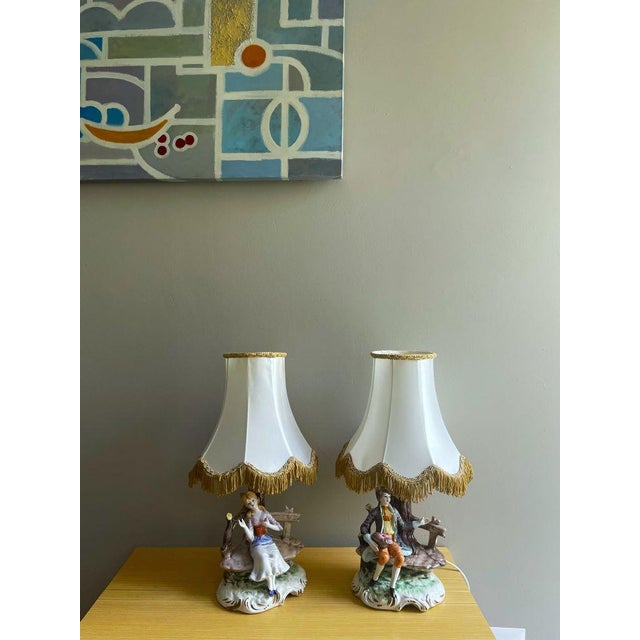 Illuminate your space with timeless elegance and artistry embodied in our exquisite pair of Capodimonte porcelain lamps,...