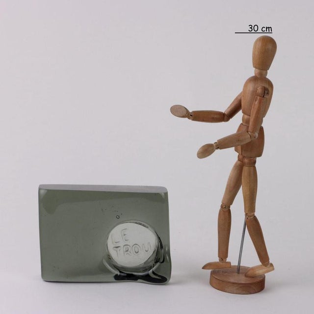 Glass ashtray with a rectangular base with a biomorphic upper part. 'Le Trou' writing in relief. Author's signature...