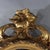 An antique Louis XIV style wall mirror, crafted from carved gilt wood, dating to approximately 1880. Its frame is carved...