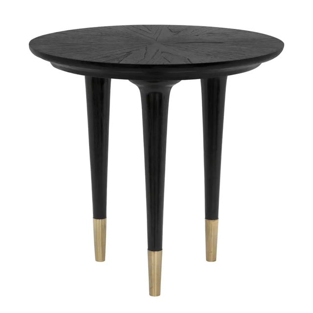 These simple round side tables pair charcoal black finished sungkai wood with brass cap legs for a look both modern and...
