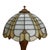This antique table lamp features a stained and leaded glass shade, characteristic of the Bradley & Hubbard quality, dating...