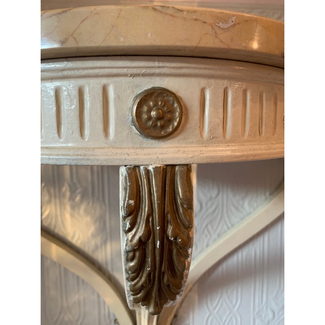 Wall-mounted, demi-lune console table; Carved, painted wood base with cabriole legs, gilt acanthus and rosette details and...