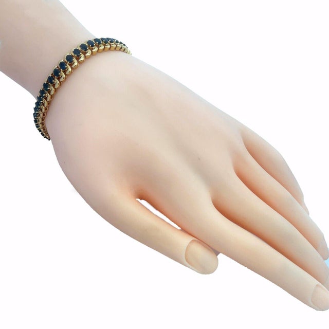 This lovely bracelet is crafted from 14k yellow gold featuring polished chasing S links with an oval shape prong set...