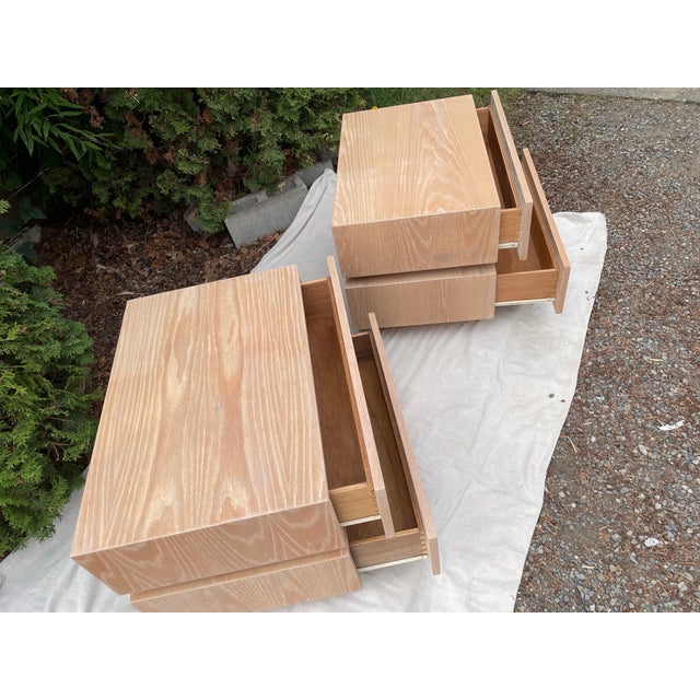 A pair of original high quality vintage stacked box nightstands. These nightstands feature white oak with a light white...