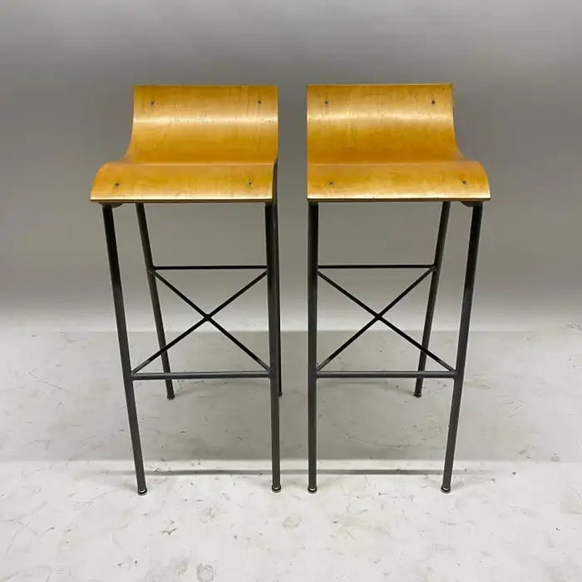 Pair of APR barstools, rendered in a sculptural architectural welded steel powder coated frame with a hand molded bent...