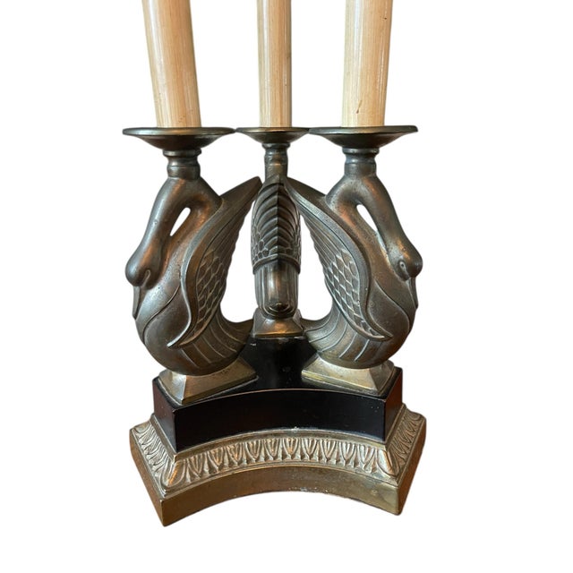 Vintage table lamp by Ethan Allen featuring an elegant swan motif base and triple candle-style columns. Designed in a...