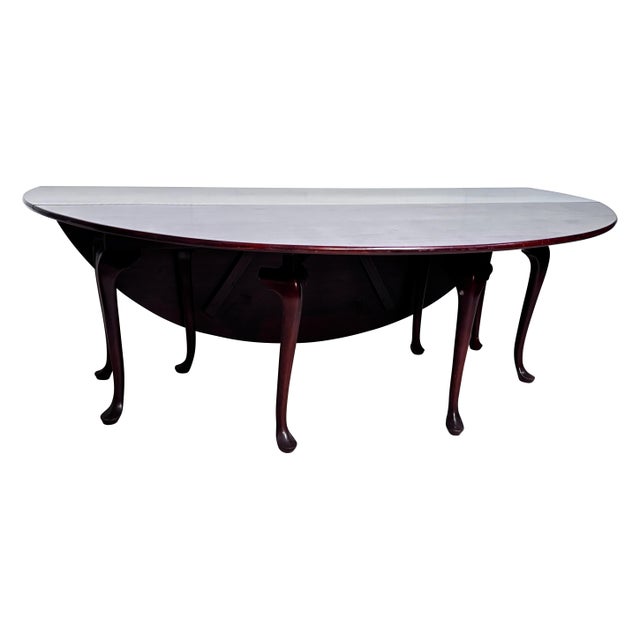 Outstanding design and quality mahogany drop leaf table. Often referred to as a “wake” or "hunt" table, this extra-long...