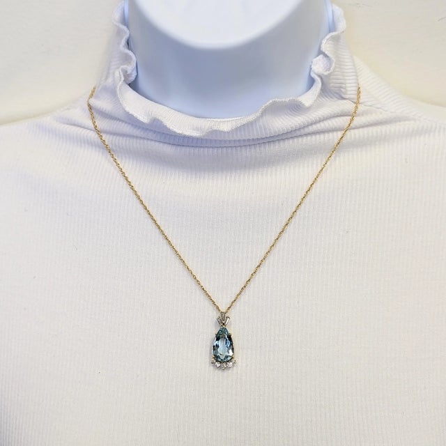 Beautiful 5.30 ct. aquamarine pear shape with 0.60 ct. good quality white diamond rounds and baguettes. Handmade in 14k...