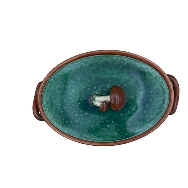 A 1930s Tellurite majolica casserole dish from Belgium, featuring a glossy green glaze, basket-weave relief, and a...