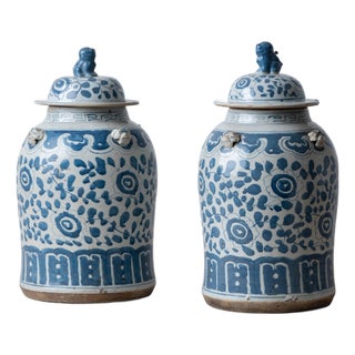 Pair of Chinese Blue and White Glazed Jars With Foo Dog Finials For Sale