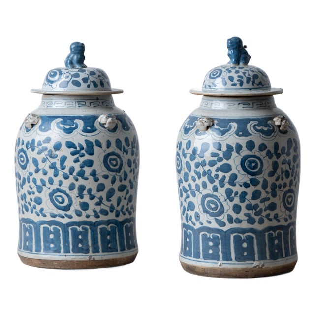 Pair of Chinese Blue and White Glazed Jars With Foo Dog Finials For Sale