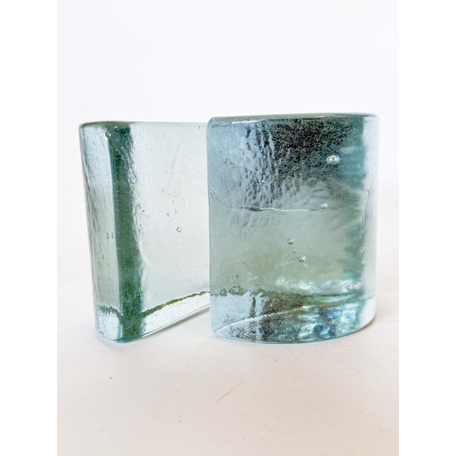 A stunning pair of 1960 or 70s Half Moon glass bookends designed by Wayne Husted for Blenko in a crisp clear bottle blue-...