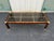 1970’s era coffee table displaying clear Hollywood Regency and Mid-Century Modern styles. An elegant faux tortoiseshell...