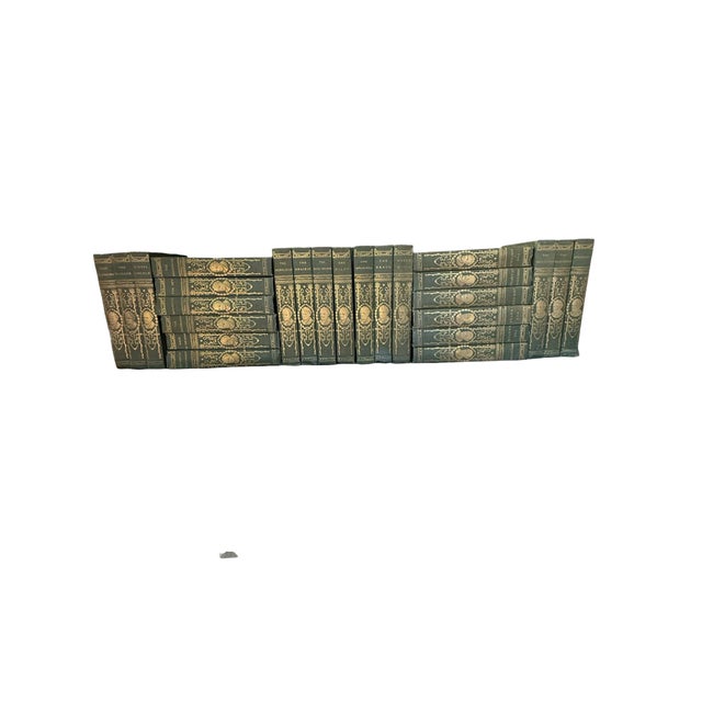 Offering an expansive, highly decorative grouping of 25 antique uniform hardcover literary books featuring the works of...