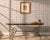 A charming French steel, marble, and bronze console table crafted in the style of Parisian pâtisserie or boucherie tables...