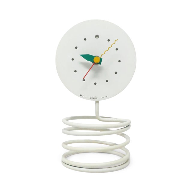 A striking postmodern table clock by Wakita featuring a sculptural white coiled spring base supporting a minimalist white...