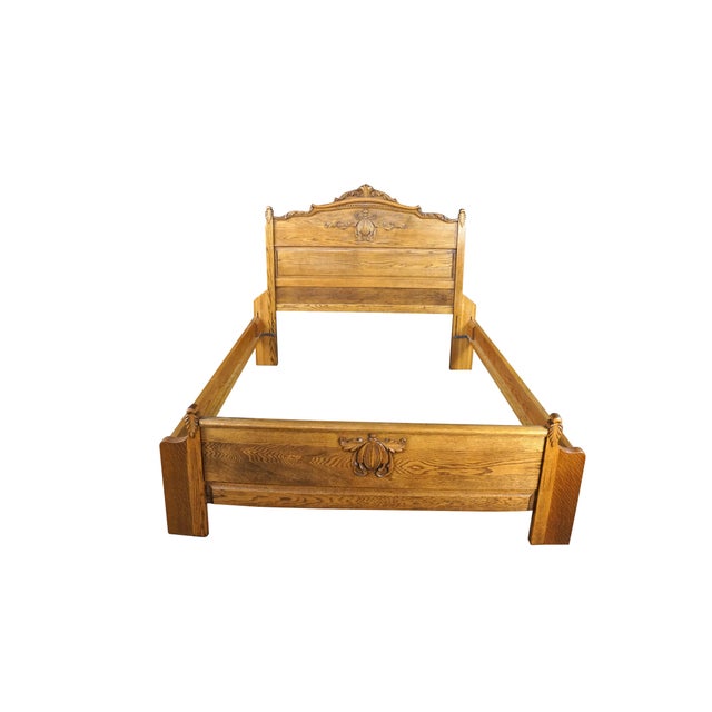 This antique Victorian oak bed frame, which has been modified or sized to accommodate a queen-size mattress, is crafted...