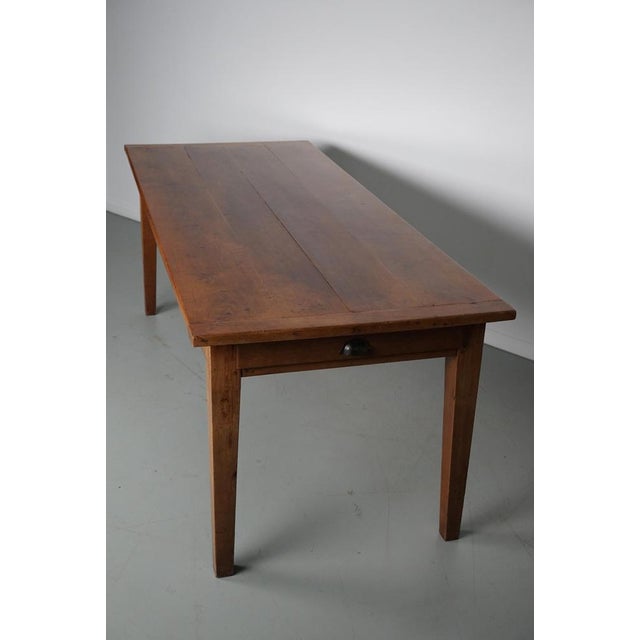 This elegant table was made in Southern France in the early 20th century. It has a tabletop from fruitwood with beautiful...