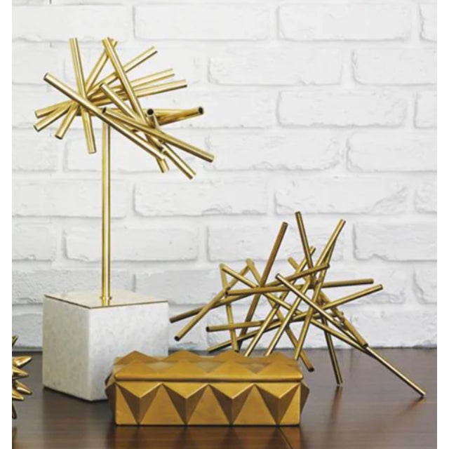 This tubular burst object with stone base will add a dynamic, sculptural pop to any tabletop arrangement. Beautiful...