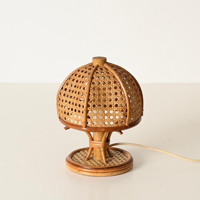 Gorgeous pair of mid-century organic table lamps entirely crafted in bamboo, curved rattan, and vienna straw. These lovely...