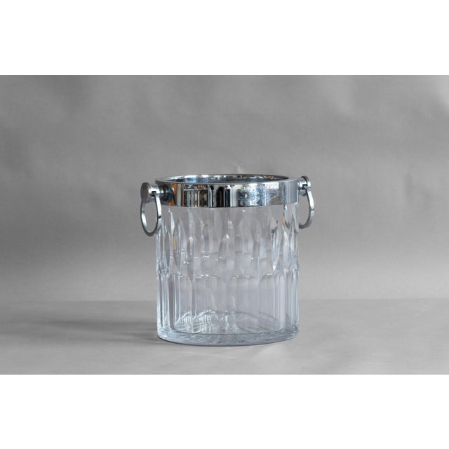 Moulded glass ice bucket with chrome rim and handles. Circa 1970.