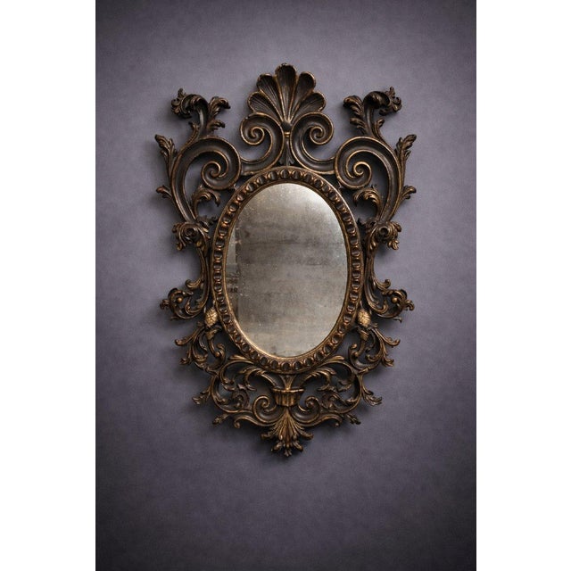 Antique louis xv style mirror, richly carved with scrolling foliage, shells, and other foliage motifs, typical of the...