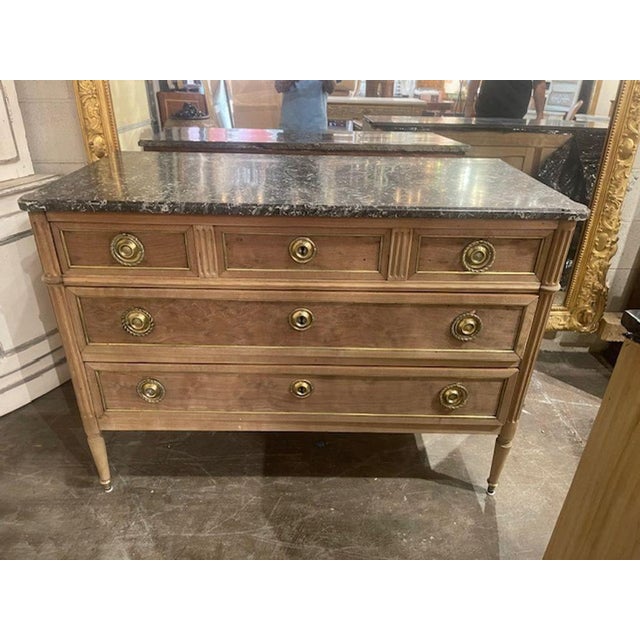 The French Bleached Mahogany Directoire' Commode is an antique piece of furniture that adds a touch of elegance and...