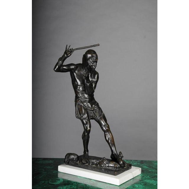 Bronze patinated, the standing Pied Piper with pipe, on a rectangular base with rats. The base is signed by Georg...