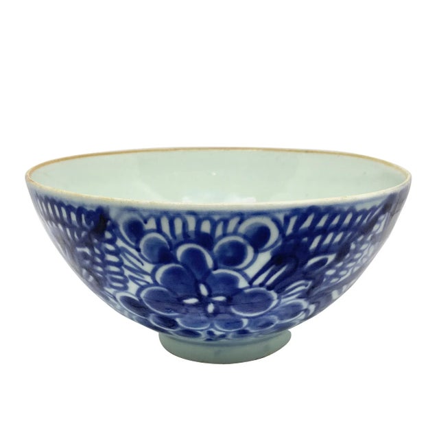 Early 19th Century blue and white Chinese porcelain bowl. The bowl has a plain interior with a small flower at the center....
