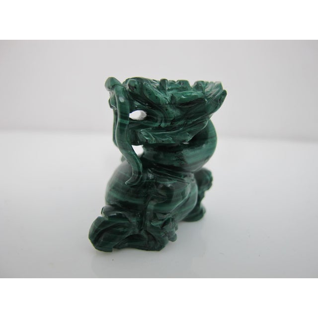 Chinese miniature Malachite temple dog or foo dog figurine. Hand-carved from vibrant green malachite stone featuring the...