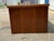 A handsome Mid-Century Modern low-profile walnut console featuring warm wood tones, clean architectural lines, and...