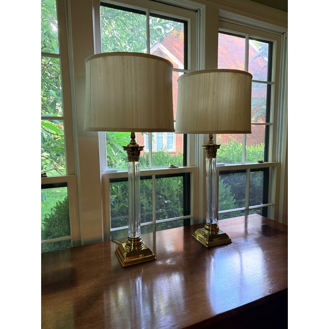 Pair of Remington Crystal Column Lamps Neoclassical lamps with square brass base, fluted crystal columns and a laurel...