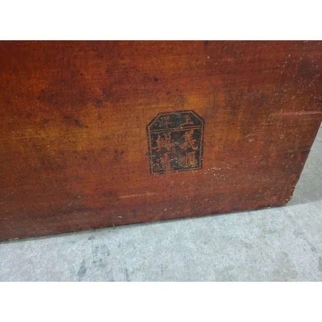 A 19th-century Chinese camphor wood trunk. This antique Chinese camphor wood chest features a beautifully hand-painted red...