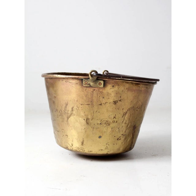 An antique E. Miller brass hearth pot dating to the 1870s. This substantial No. 19 apple butter kettle features a warm...