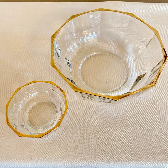 Set of two vintage Italian faceted crystal bowls with gold-trimmed rims. Each bowl features ten crisp facets that catch...