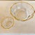 Set of two vintage Italian faceted crystal bowls with gold-trimmed rims. Each bowl features ten crisp facets that catch...