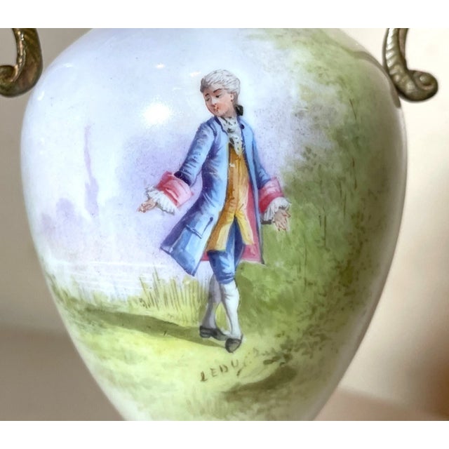 This antique miniature vase from Sèvres is a true gem for collectors. The delicate porcelain and bronze construction,...