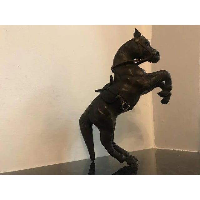 A small leather horse figurine made by hand from the 1950s. a beautiful horse covered with leather with a saddle with all...