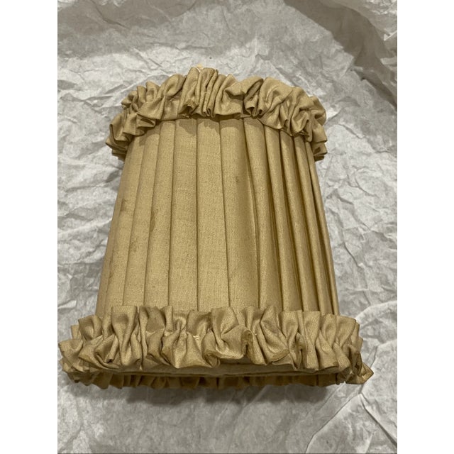 Good condition This shade features a classic pleated design in a warm champagne fabric that has a beautiful, soft sheen....