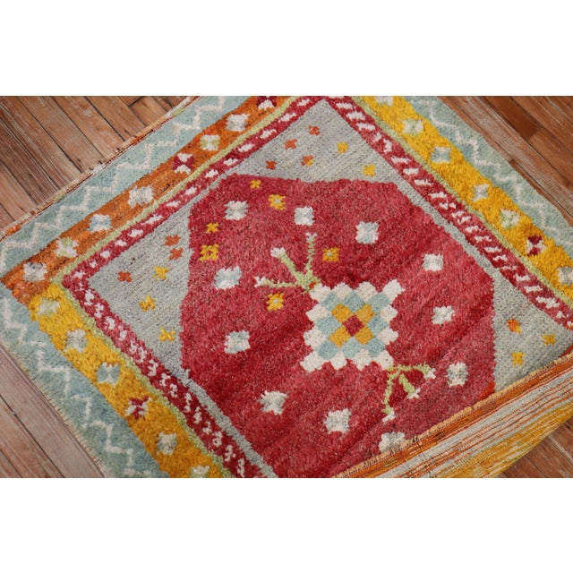 A Turkish Tulu rug with saturated colors in predominant red, blue gray and orange tones Measures: 3'6" x 3'10".