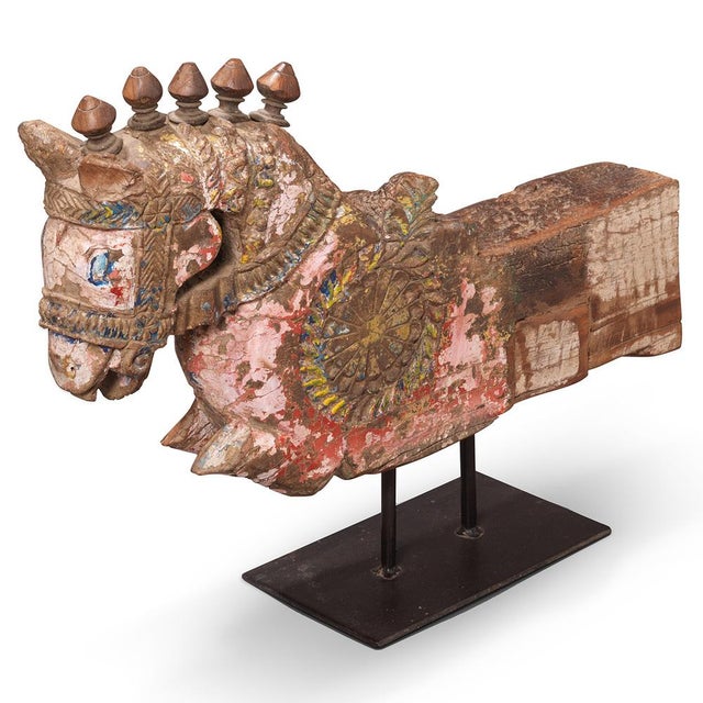 Gujarat, early 20th century - a carved vintage wooden horse, mounted on a simple iron stand. The piece features a stylised...