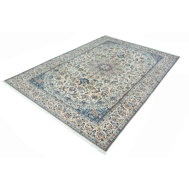 An elegant masterpiece from Nain's traditional art of knotting: This hand-knotted oriental rug in fine 9-La quality...